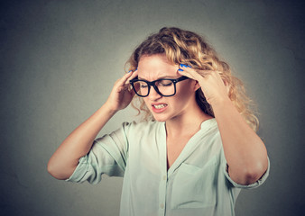 sad young woman in glasses with worried stressed face expression