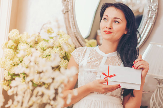 Woman holding a white card