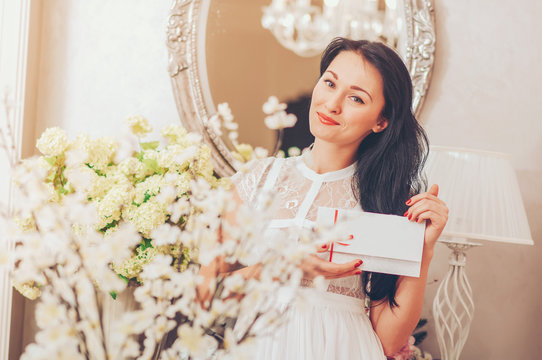 Woman holding a white card