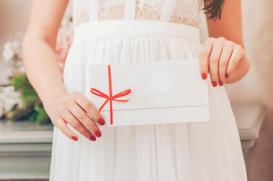 Gift card - closeup of woman showing sign card.