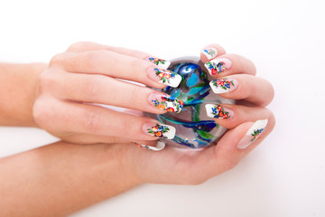 Beautiful female hands with nice art manicure on white background
