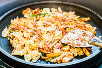 One of Korean favorite : Korean spicy stir fried vegetable, chicken and Korean spicy sauce (Gochujang) in big hot pan know as Dak Galbi