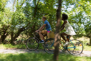 Obraz premium Young multiethnic couple having a bike ride in nature