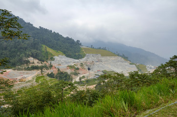 Fototapeta na wymiar Hydroelectric dam under construction, surrounded by cloudy sky a