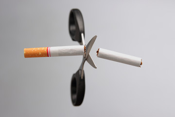stop smoking / cigarette being cut with scissors