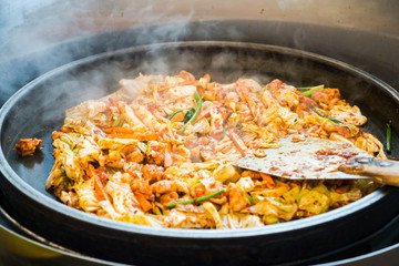One of Korean favorite : Korean spicy stir fried vegetable, chicken and Korean spicy sauce (Gochujang) in big hot pan know as Dak Galbi