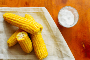 rustic concept just cooked corn with salt on table