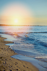 Breakwaters in the Baltic sea over the sunset