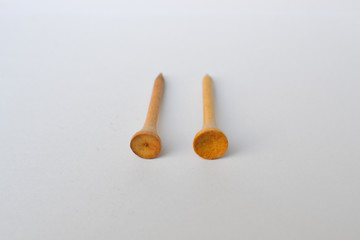 wooden golf tees on white background, sport time