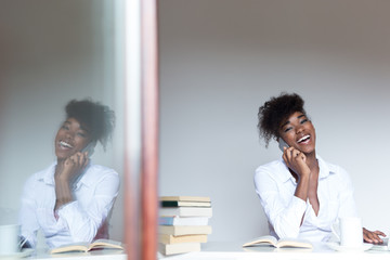 Smiling african american woman having mobile phone conversation