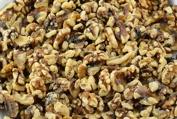 Close up of shelled walnuts halves and pieces