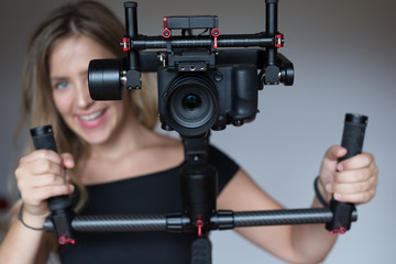 woman videographer with gimball video slr