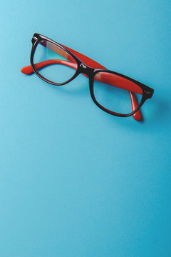 pair of red plastic-rimmed eyeglasses