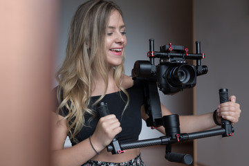 woman videographer with gimball video slr