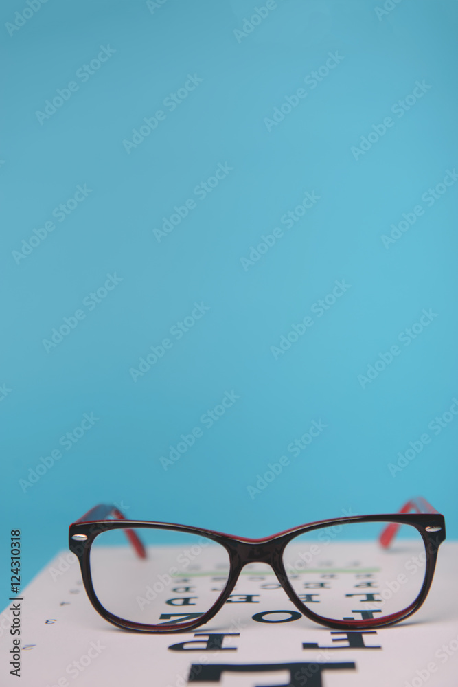 Wall mural glasses lying on snellen test chart