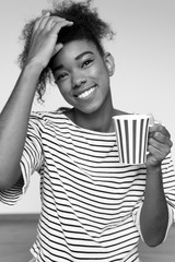 Close up portrait of a young  afro american woman enjoying cup o