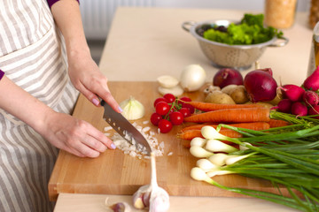 Young Woman Cooking in the kitchen. Healthy Food