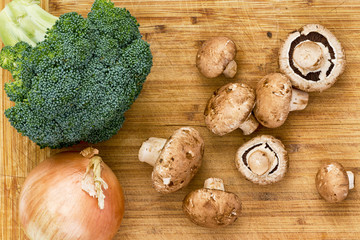Top down view on mushrooms, broccoli and onion