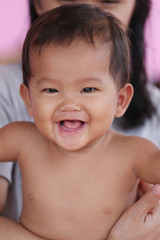 Asian baby smiling happily and <b>good mood</b>. - 240_F_124311162_A78CI9ZRKB2Mua3wzcA796OhFQdLtl9t