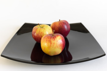 three apples on plate