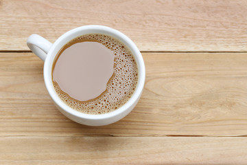 hot coffee in a white Coffee cup on wooden table.