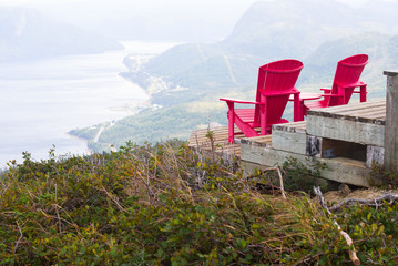 Two red chairs at a Lookout Trail summit in Gros Morne, Newfoundland