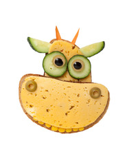 Funny cow made of bread and cheese on white background