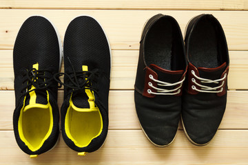 Sport shoes on a wooden table. Shot from above in flat lay style