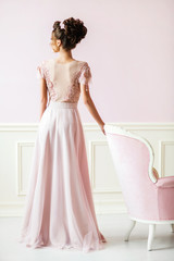 Fototapeta premium Beautiful young woman in a pink dress