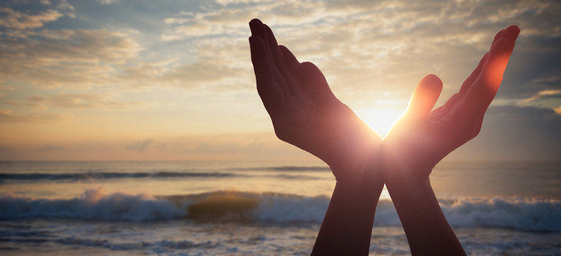silhouette of female hands during sunset.