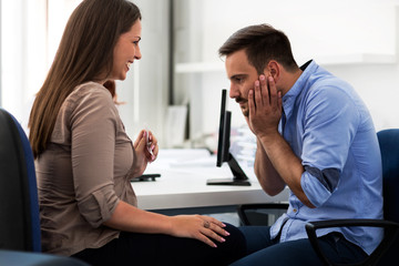 Young happy mother holding ultrasound, couple visit gynecologist