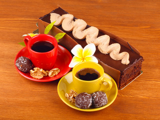 chocolate cake with two cup of coffee and chocolate balls