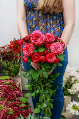 Woman holding bouquet of red roses