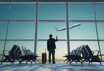 young businessman waving good bye at airport