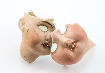 Broken doll parts on white background - Abstract conceptual image