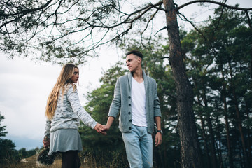 Stylish and fashionable young beautiful happy couple posing. Boho style.