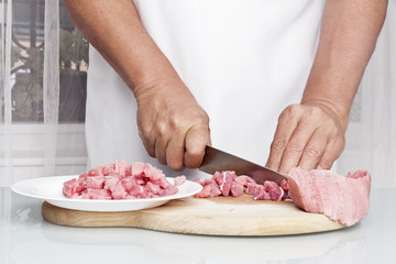Obraz na płótnie Canvas Preparing meat, cutting. Making enchilada tortilla with beef.