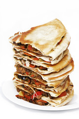 Pile of quesadillas with chicken and vegetables on the isolated on white
