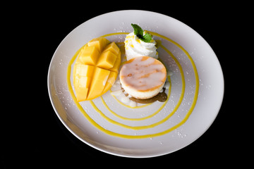 Mango and ice cream decorated with whipped cream.