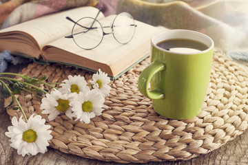 Books with reading glasses on desk