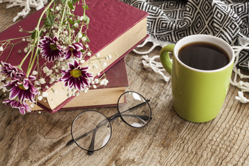 Books with reading glasses on desk