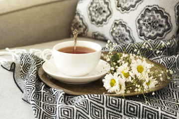 Tea with flowers on sofa