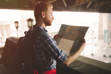 Tourist backpacker using map to travel
