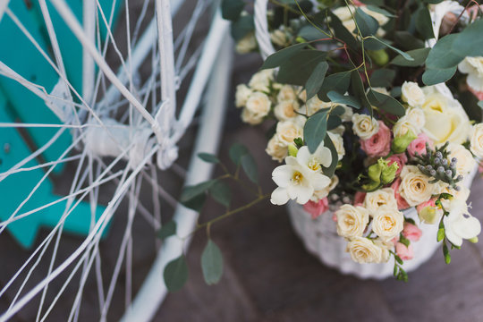 Fototapeta Photo zone for guests at wedding reception. Closeup of white vintage bicycle, turquoise background, flowers and eucalyptus in basket.