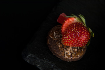 cake with strawberries on dark background decorative stone