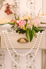 flower composition in a table drawer as a decoration of wedding candy bar