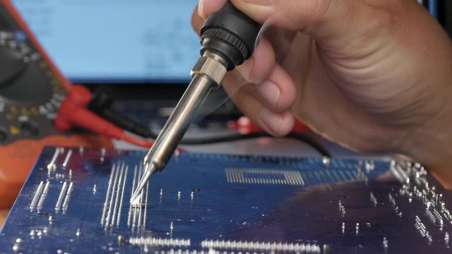 Technical fixes motherboard. Soldering Iron and motherboard

