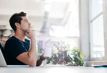 Businessman sitting in office and thinking