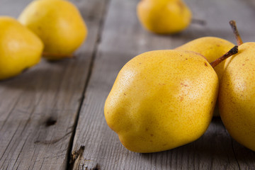 Fresh ripe organic yello pears on rustic wooden table, natural background, diet food.