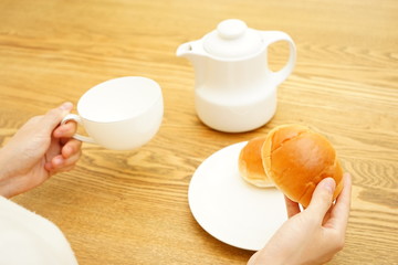 Young Asian woman having a breakfast in her room